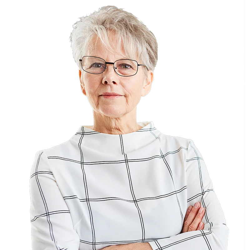 older woman with her arms crossed, looking at the camera with a thin smile