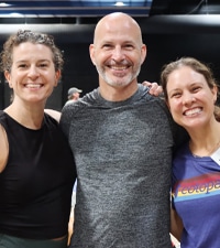 two women beside a man, everyone is smiling