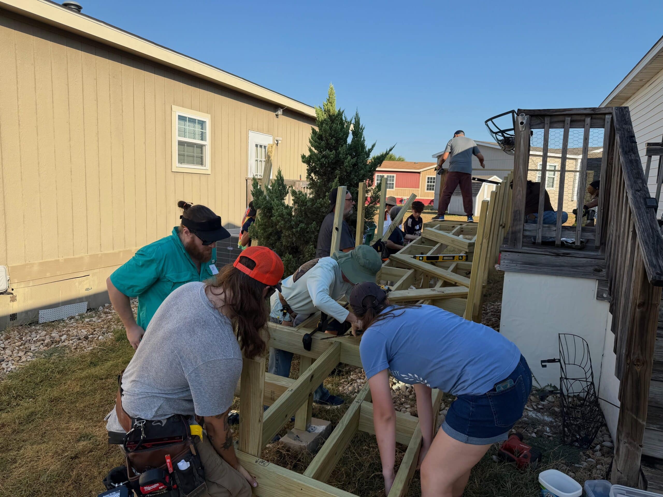 Volunteers placing the lower part of a ramp.